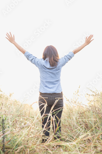 Young beautiful woman with hands raised