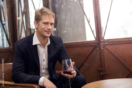 Portrait of a handsome Businessman sitting in restaurant, Man with Business Concept. photo