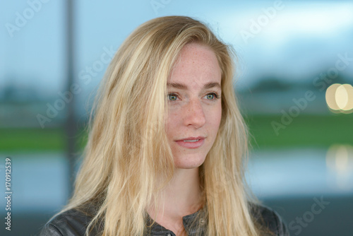 Young blond woman looking away