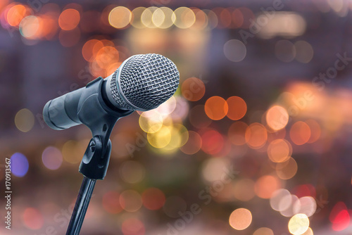 microphone in concert hall, restaurant or conference room blurred background.