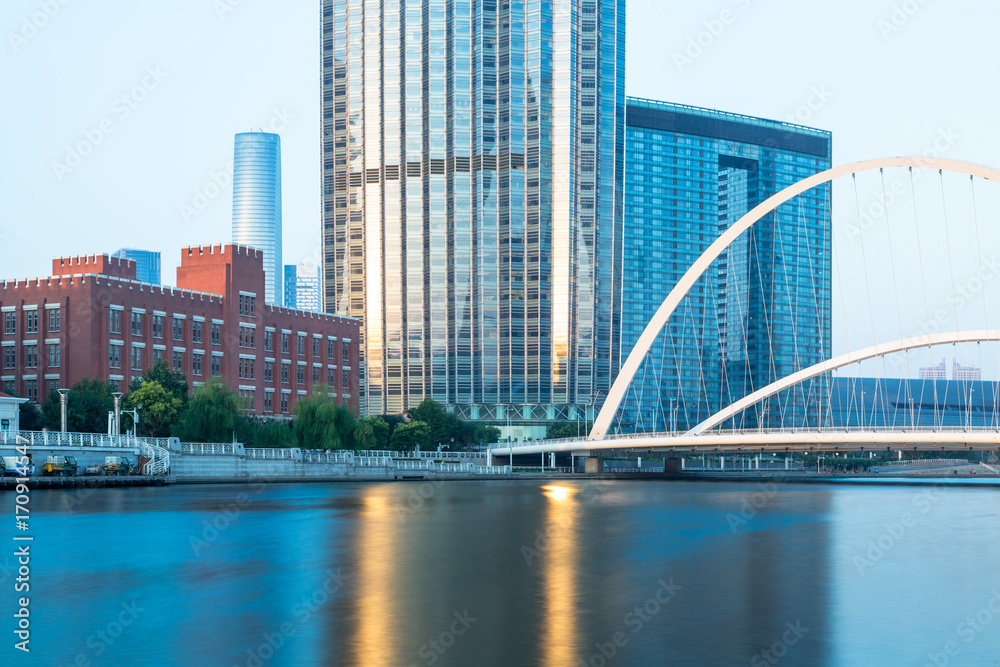 Fototapeta premium Tianjin Hai river waterfront downtown skyline with Dagu bridge,China.