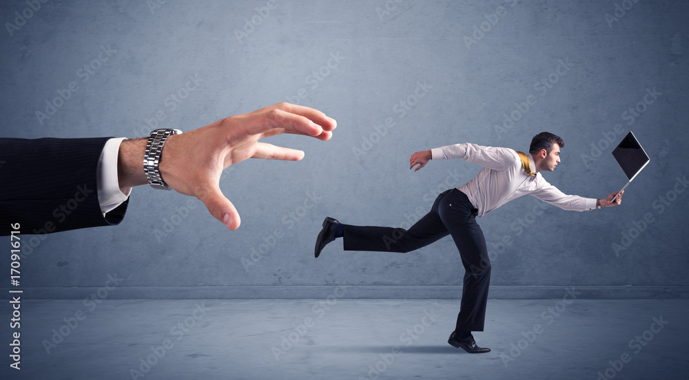 Fototapeta premium Businessman running from hand