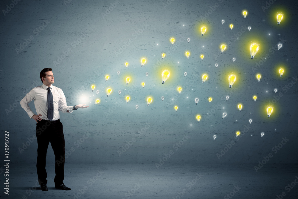 Businessman holding lightbulbs Businessman holding lightbulbs