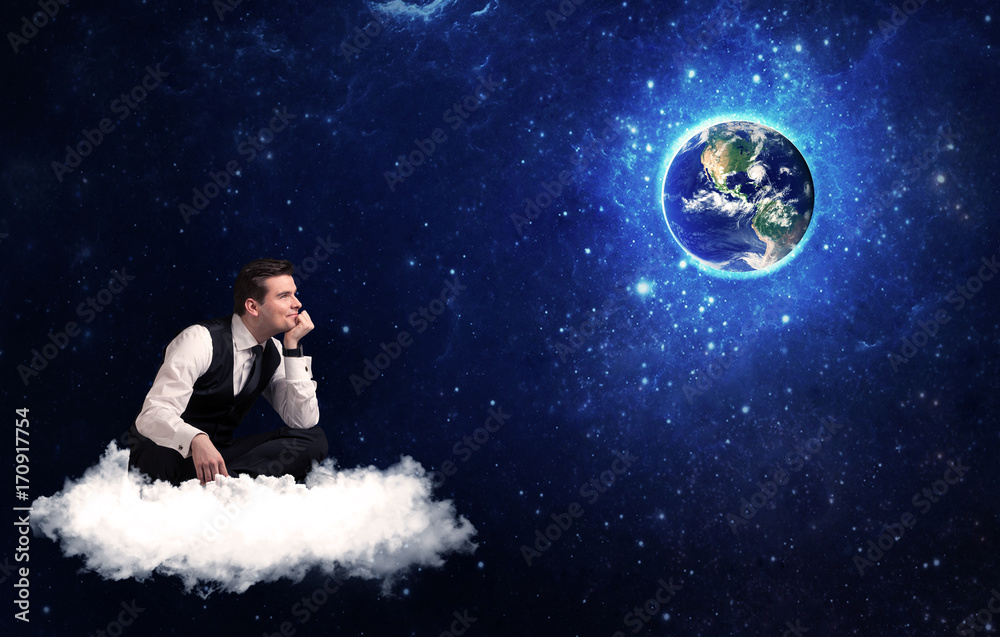 Man sitting on cloud looking at planet earth Man sitting on cloud looking at planet earth