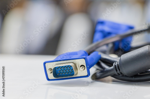 old dirty VGA tech cable connector of computer on table white Blur meeting room background