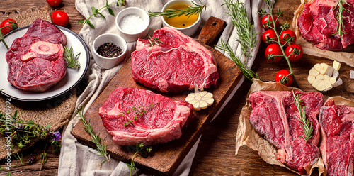 Raw beef meat on a dark wooden board.