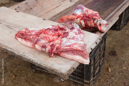 Pieces of pig over wooden trough