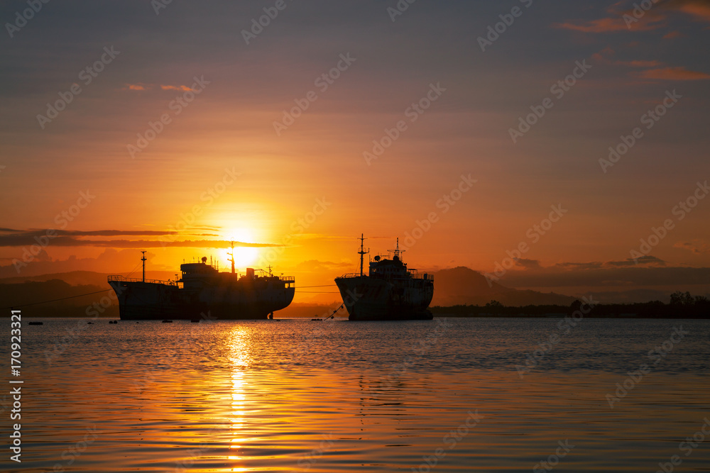Fototapeta premium big transport boats in the morning sunrise.