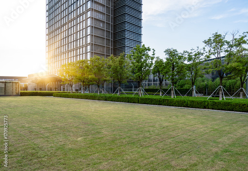 modern office block with green lawn against sunlight,suzhou,china.