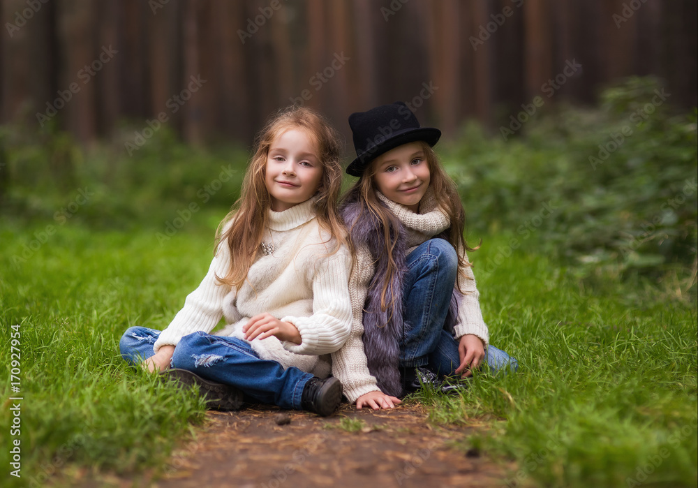 Two cute twins girls sisters walk
