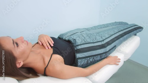 Young woman relaxing during the pressotherapy procedure