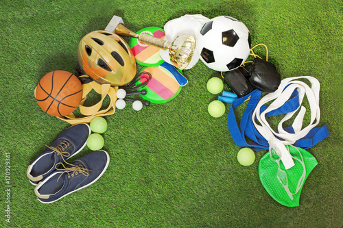 Many Sports, equipment for training and stuff on green grass. Background with space for text or image.