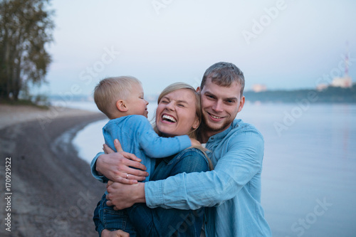 happy family huggging shore