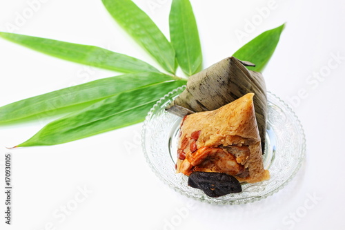 Fresh bamboo leaf and two pieces of zongzi photo