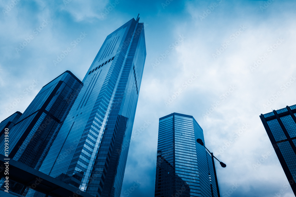 modern skyscrapers against sky,blue toned,Hong Kong,China. modern skyscrapers against sky,blue toned,Hong Kong,China.