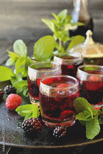 berry juice in a glass with berries, selective focus