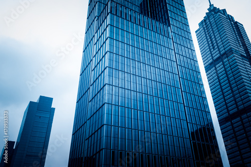 architectural complex against sky in downtown tianjin china.blue toned.