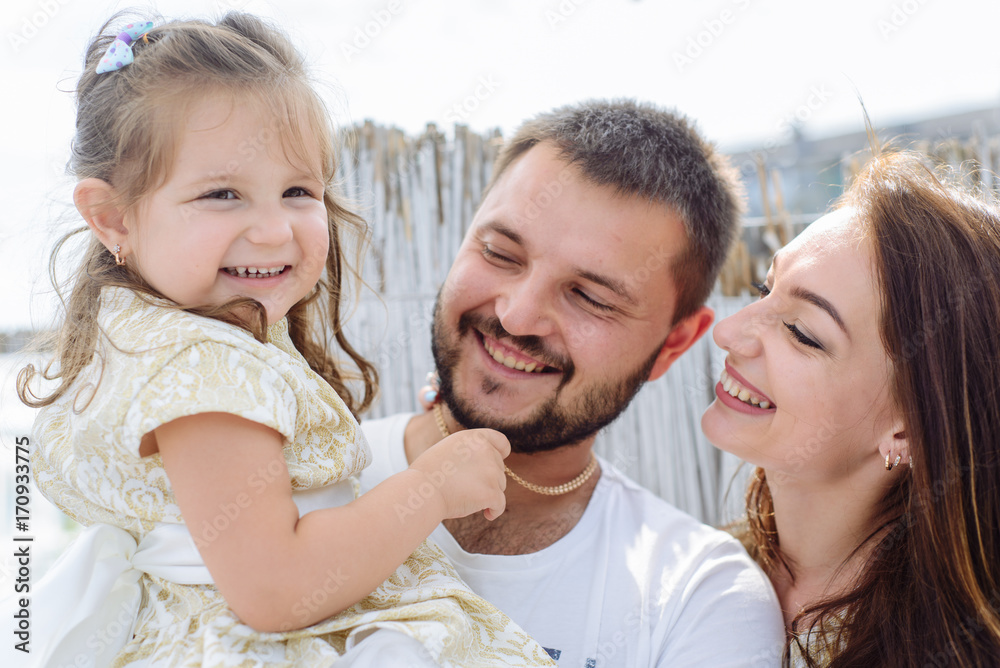 Fototapeta premium Happy loving family. portrait of mom with dad and daughter