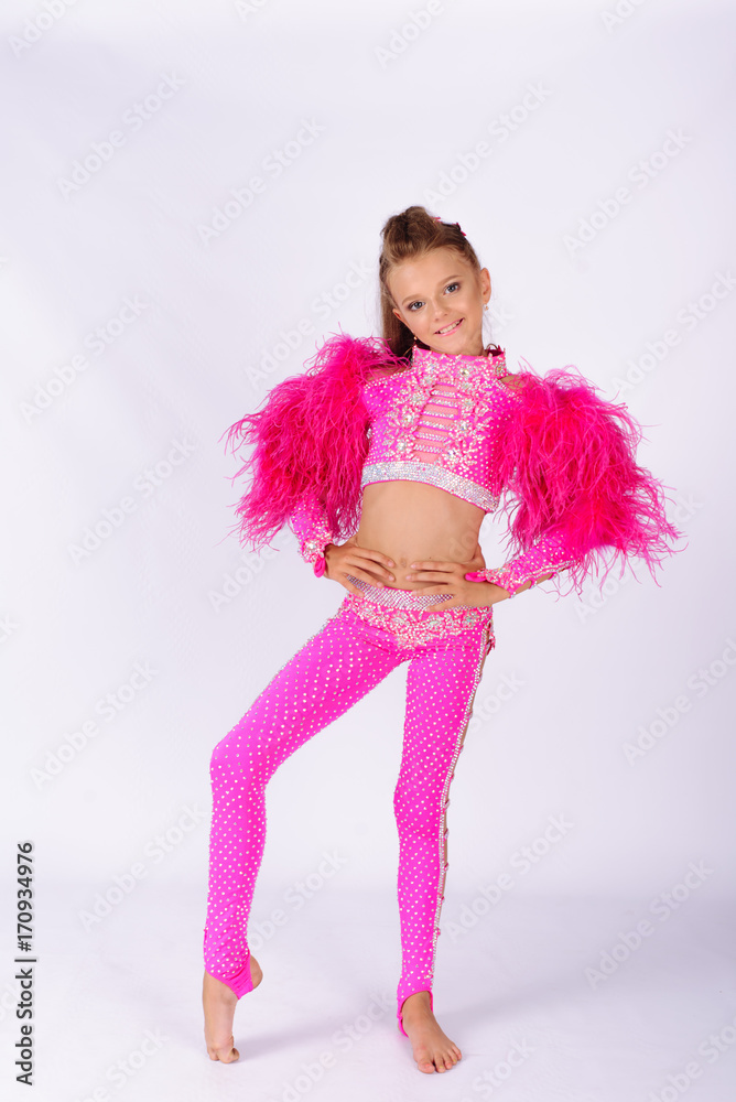 Flexible little girl gymnast doing acrobatic exercise on white background Flexible little girl gymnast doing acrobatic exercise on white background