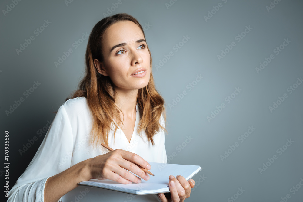 Thoughtful beautiful woman taking notes Thoughtful beautiful woman taking notes