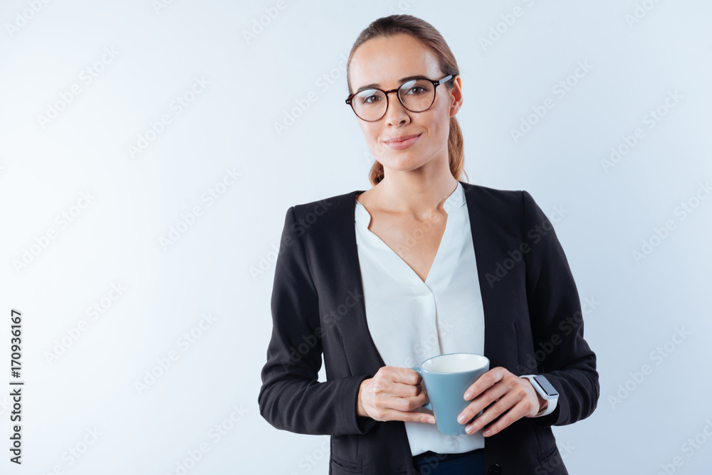 Serious smart businesswoman holding coffee Serious smart businesswoman holding coffee