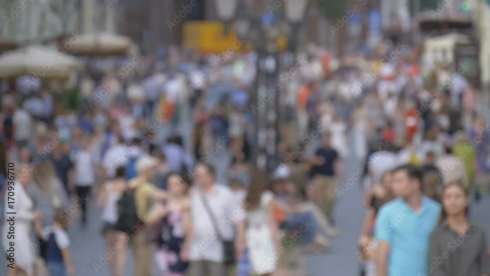 A big crowd of people walking down the street. Out of focus A big crowd of people walking down the street. Out of focus