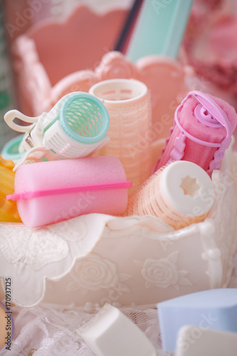 Cosmetic hair roll in mix candy color and makeup brushes.