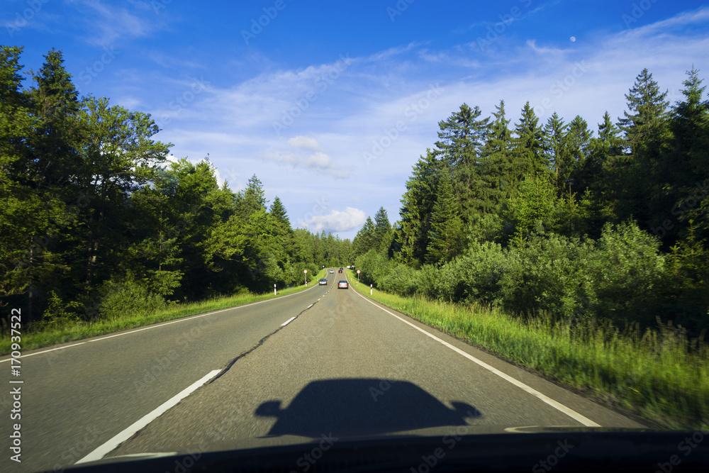 Drivers point of view. Shadow of car driving on Highway , Black Forest Region