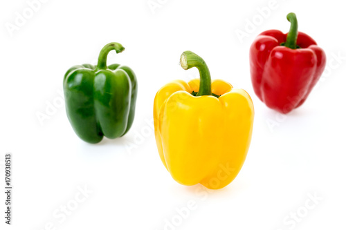 yellow green and red pepper on white background