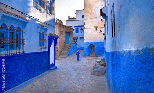A Moroccan woman in national clothes is walking down the street of the city © Tortuga