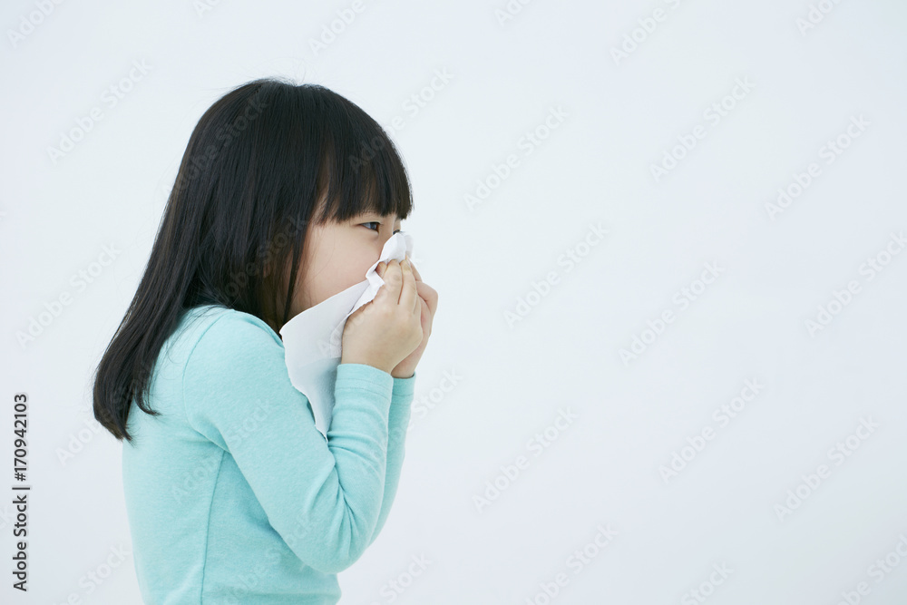 Little Korean girl blowing her nose Little Korean girl blowing her nose