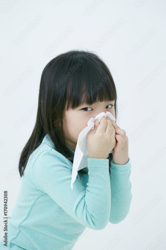 Little Korean girl blowing her nose Little Korean girl blowing her nose