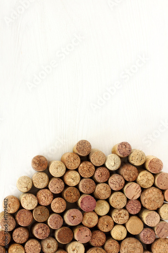 mountain open flavors/ flat layout of wine corks of different varieties on a light wooden background top view