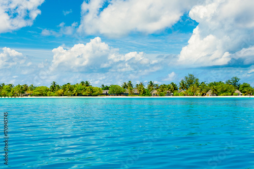 Beautiful sandy beach with sunbeds and pool in Indian ocean, Maldives island © Myroslava