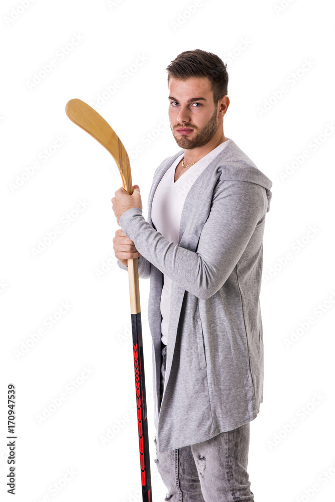 Portrait of a handsome man posing for camera with hockey stick in his hands Portrait of a handsome man posing for camera with hockey stick in his hands