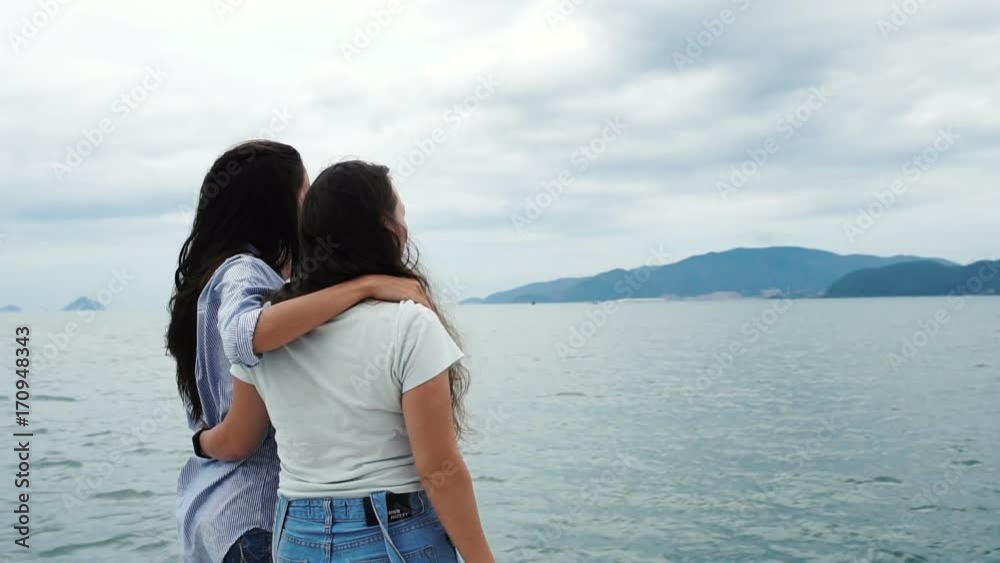 Two women looking at the sea and talking to each other on yacht Two women looking at the sea and talking to each other on yacht