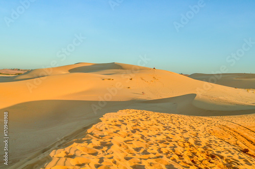 Beautiful white sand dunes ripples and footprint in sunrise morning  Muine  Vietnam. Vacation concept background.