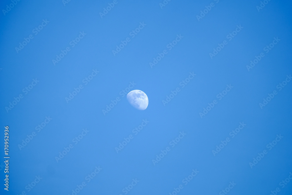 Crescent moon with blue sky in late afternoon Crescent moon with blue sky in late afternoon