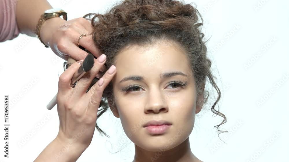 Woman having makeup applied. Hands of visagist working, brush. Woman having makeup applied. Hands of visagist working, brush.