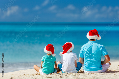 Father with kids at beach on Christmas