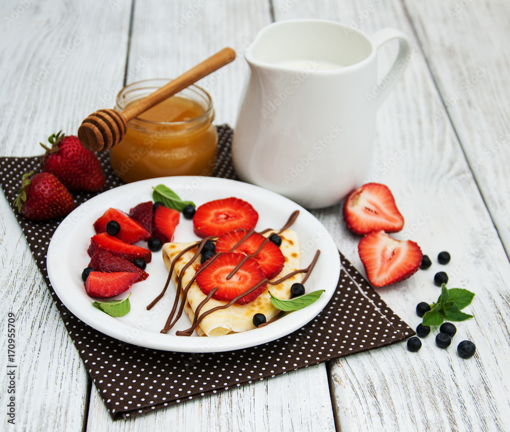 crepes with strawberries and chocolate sauce crepes with strawberries and chocolate sauce