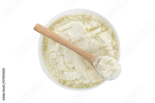 A bowl of powdered milk and spoon. Top view.