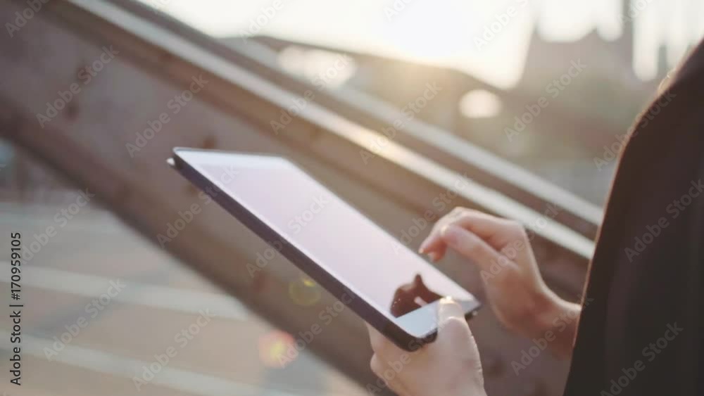 Businesswoman Using Digital Tablet Close Up, Walking in Sunny Morning City. SLOW MOTION. STEADICAM Stabilized Shot. Professional Business Woman Hands using a tablet computer touchscreen. Lens Flare. 
