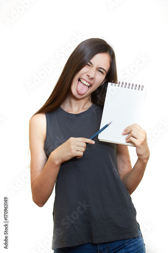 Portrait of happy smiling young woman isolated over white background. Holds a notepad and pencil