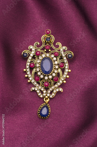 Fényképezés Vintage gold brooch with precious stones isolated on white