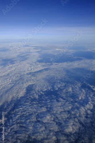 Flying above the clouds in the morning, soft focus