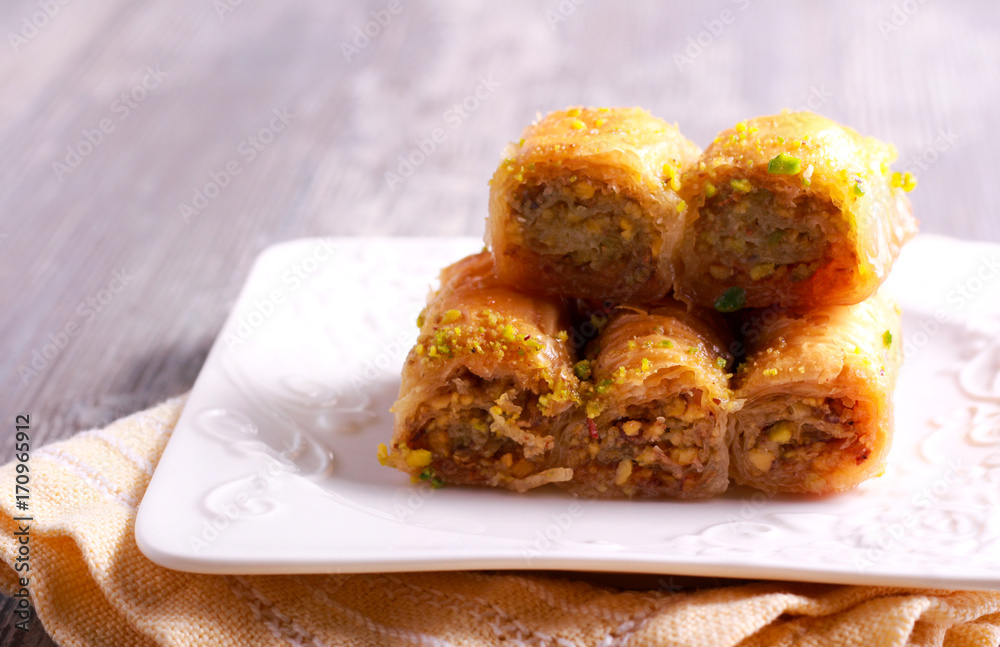 Baklava with pistachios and honey on plate Baklava with pistachios and honey on plate