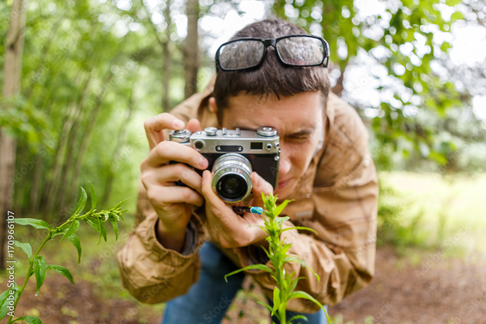 Photo of man with camera in woods Photo of man with camera in woods