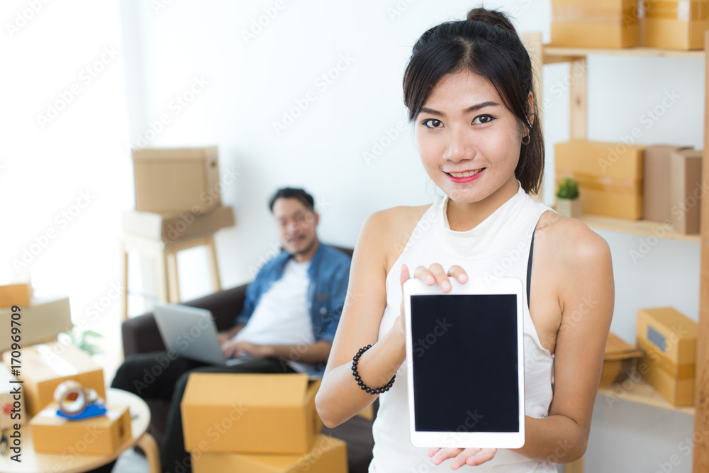 Young Asian Woman Using Tablet for Work at Home, Young Owner Woman Start up for Business Online, SME, Delivery Project, Woman with Online Business or SME Concept. Young Asian Woman Using Tablet for Work at Home, Young Owner Woman Start up for Business Online, SME, Delivery Project, Woman with Online Business or SME Concept.