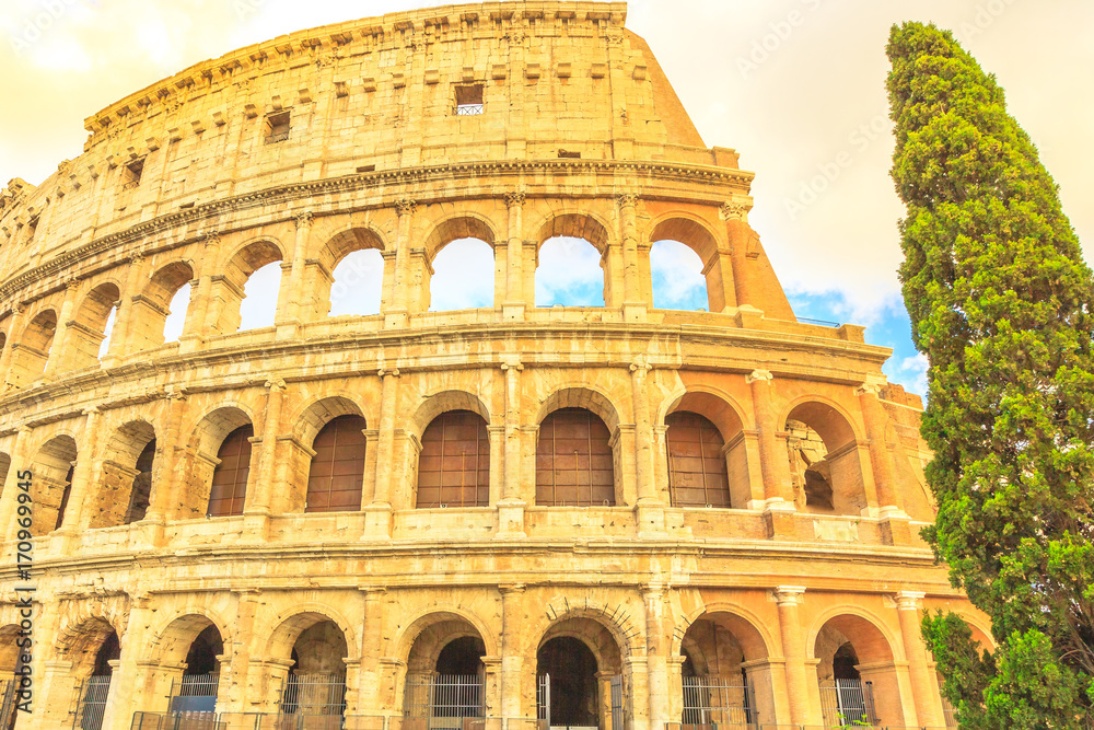 Side view of the Colosseo, Colosseum, Flavian Amphitheatre, the largest amphitheater in the world and one of the symbols of Italy. Symbol of Rome, located in historical center, Unesco Heritage Site.